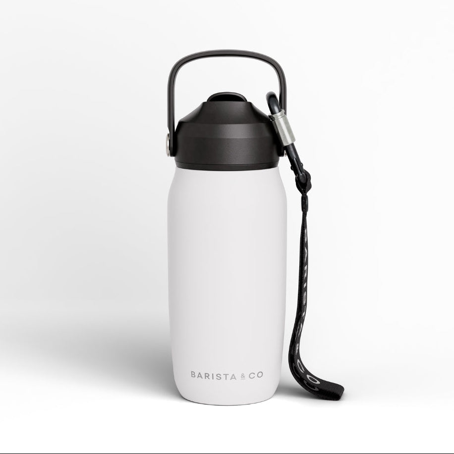 A matte white insulated water bottle with a carrying loop and wrist strap, featuring the BARISTA & CO logo near the base, set against a clean white background.
