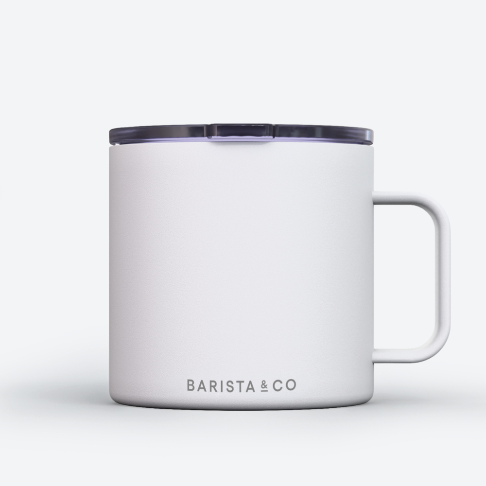 A white insulated mug with a dark translucent lid and a white handle, featuring the BARISTA & CO logo printed in gray near the bottom, set against a clean white background.