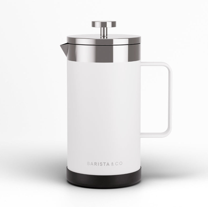 A white French press coffee maker with a brushed silver metal lid and plunger, featuring a white handle and a black base, shown on a clean white background. The brand name 'BARISTA & CO' is printed near the bottom.