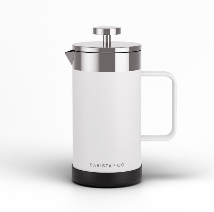 A modern white French press coffee maker with a stainless steel lid and plunger, featuring a black base and the BARISTA & CO logo, set against a clean white background.
