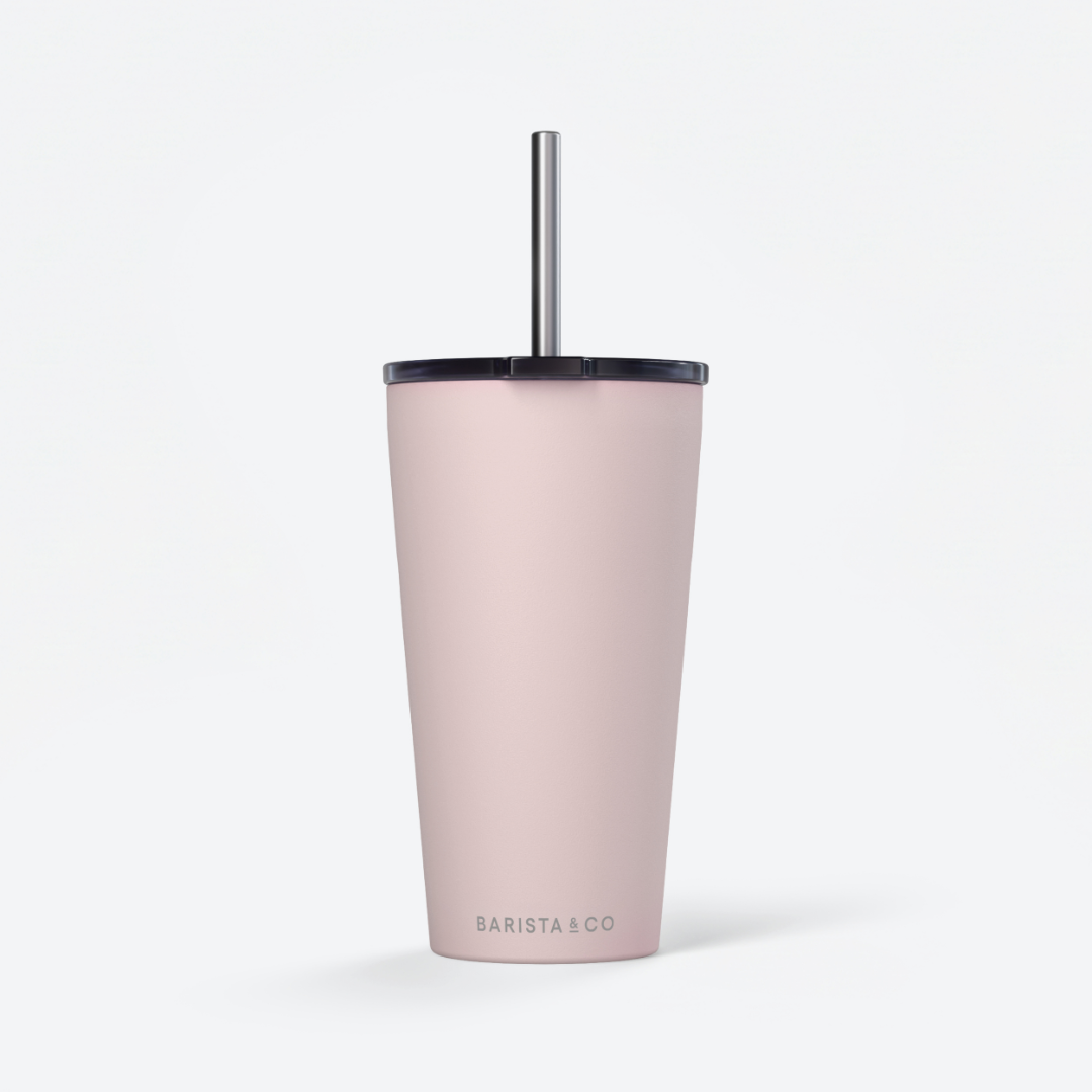 A tall, matte blush pink insulated tumbler with a black lid and a silver metal straw, shown on a clean white background. The brand name 'BARISTA & CO' is printed in a subtle gray font near the bottom.