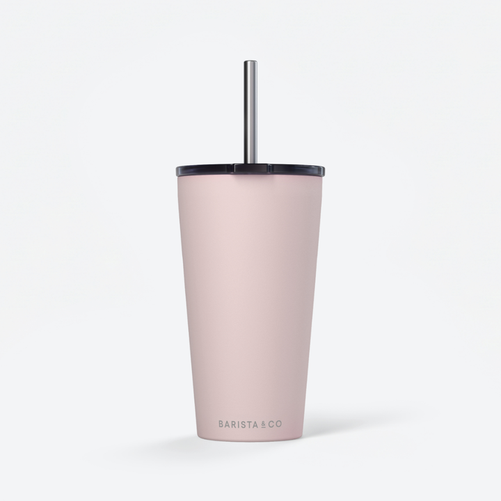 A tall, matte blush pink insulated tumbler with a black lid and a silver metal straw, shown on a clean white background. The brand name 'BARISTA & CO' is printed in a subtle gray font near the bottom.
