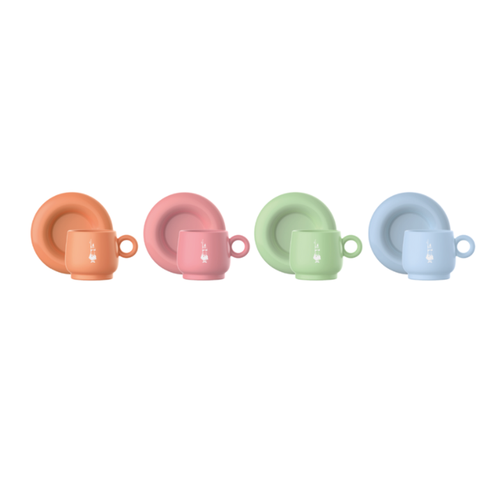 Set of four pastel-colored children's dinnerware items on a white background