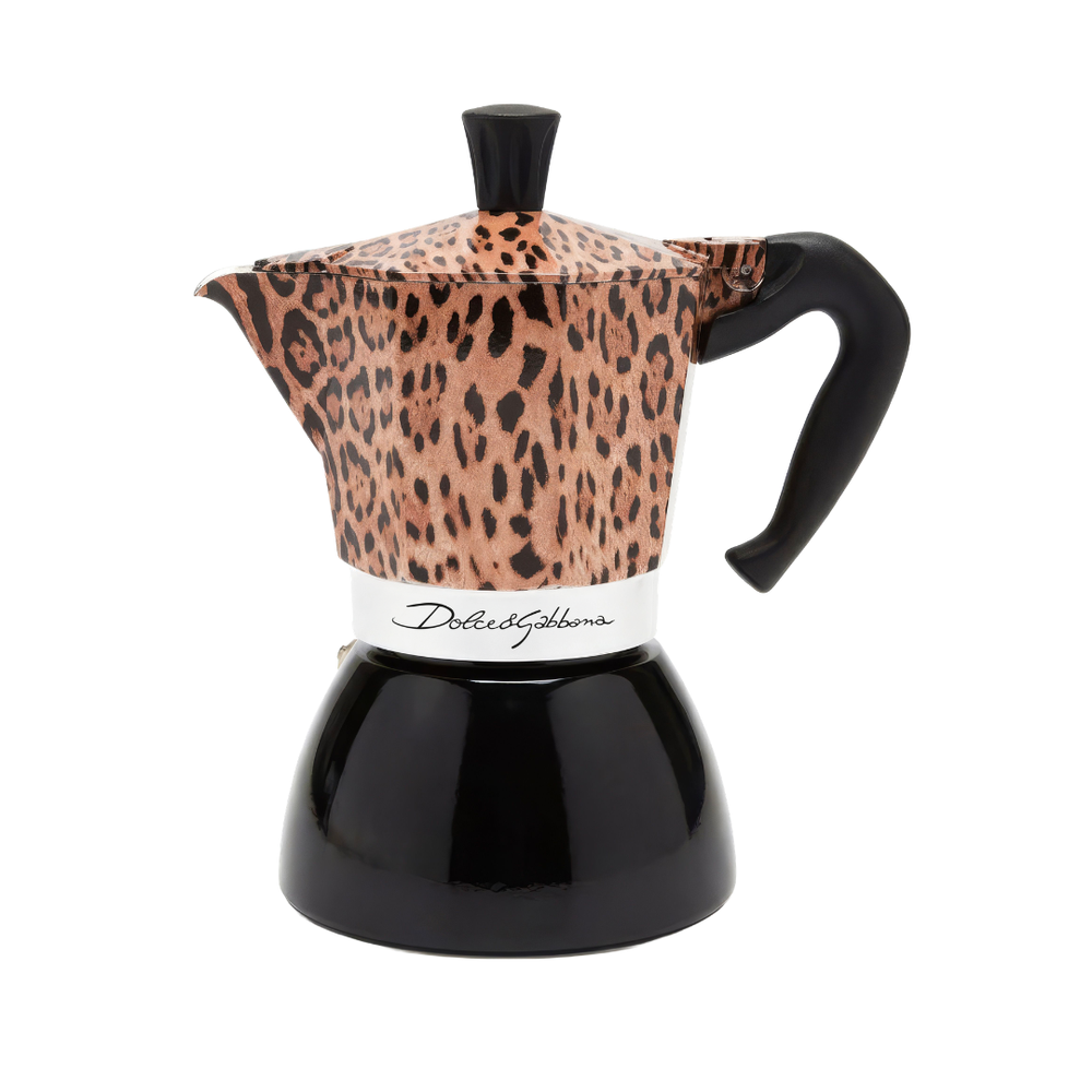 A moka pot espresso maker with a leopard print pattern on the upper body and lid, paired with a glossy black base, handle, and top knob. A white band around the middle features the script brand name 'Delia Gabbana'.